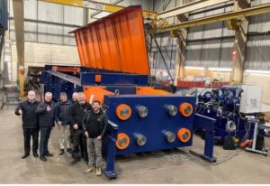 AJT and Customer stand next to the 3000 Tonne Tensile Test Machine
