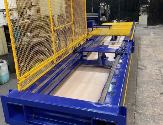 A blue horizontal tensile test machine with open yellow mesh guards