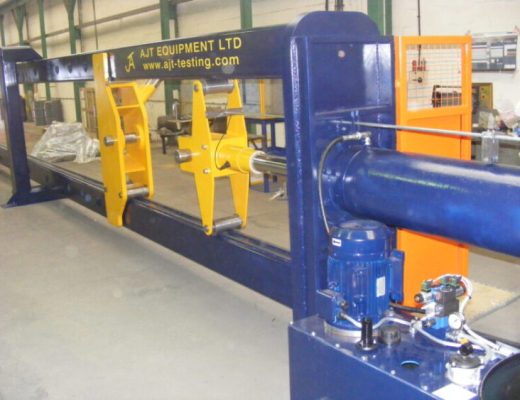 Blue Vertical Plane Horizontal Test Machine with yellow clevis and AJT Equipment stencilled on the blue test machine