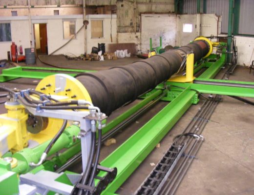 Cyclic Hose Bend Tester - a green horizontal frame, with a wide diameter hose attached at both ends to secure the hose