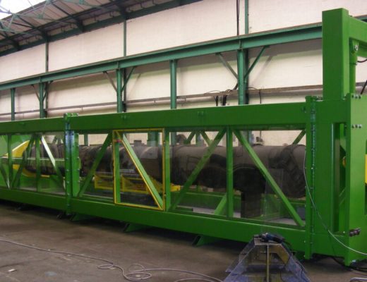 Green horizontal test machine with clear plastic viewing panes - used for testing torque in undersea cables