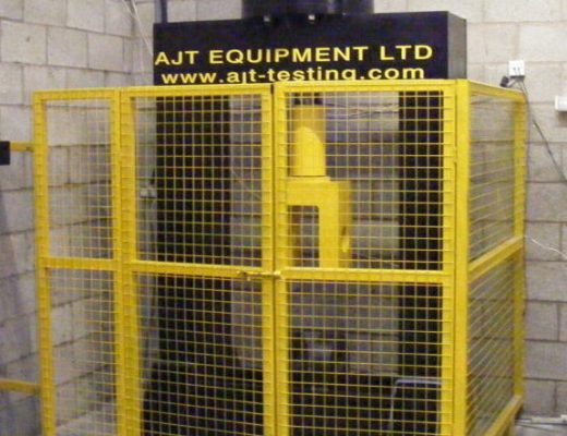 black Vertical Tensile Calibration machine with yellow mesh guards around it.