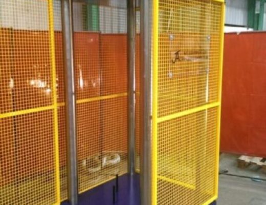 Vertical compression test frame with yellow mesh guards around it