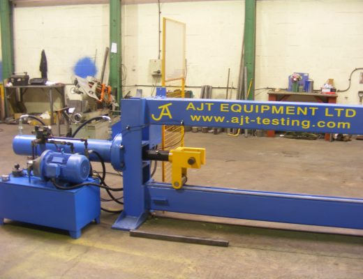 A blue horizontal vertical plane test machine with AJT Equipment written in yellow on the side.