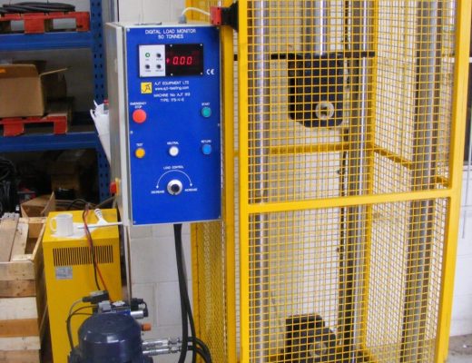 50Te vertical tensile tester - yellow with yellow mesh guards around it