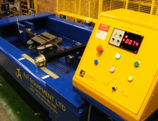 Blue Tensile Test machine with yellow control panel - guards are open showing grips inside the machine to secure customer sample